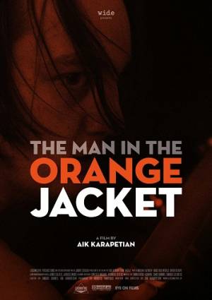 The man in the orange jacket